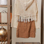 Back of boho sweater with sunflowers and fringe details